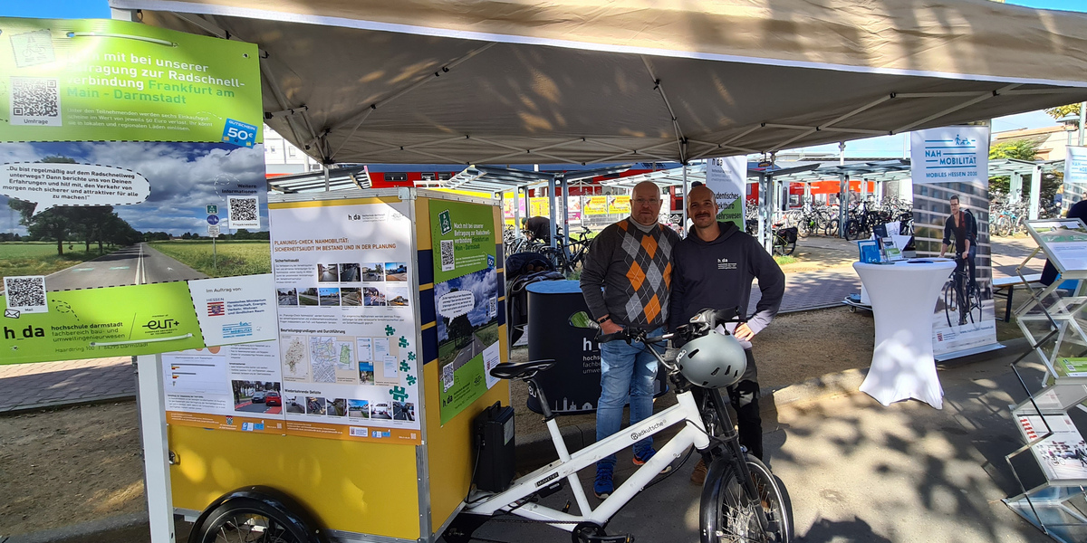 Stand der Hochschule Darmstadt auf dem Event "Radschnellweg live" in Langen mit den Mitarbeitenden Mark-Simon Krause und Thomas Marx und Schwerlastenrad